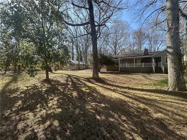 view of yard with covered porch