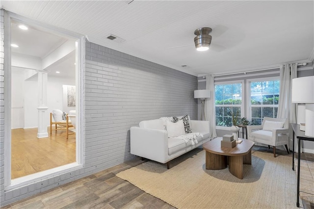 2070 Drew Valley Rd NE, Brookhaven, GA 30319 - living room featuring wood finished floors, brick wall, a ceiling fan, and ornamental molding