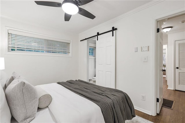 2070 Drew Valley Rd NE, Brookhaven, GA 30319 - bedroom with wood finished floors, a barn door, crown molding, and ceiling fan
