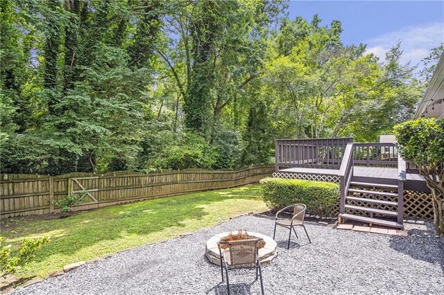2070 Drew Valley Rd NE, Brookhaven, GA 30319 - fenced backyard with an outdoor fire pit and a deck