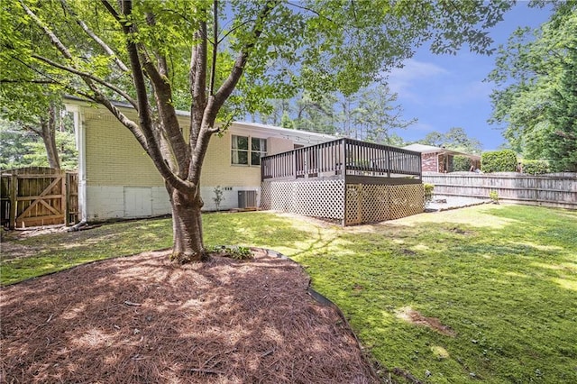 2070 Drew Valley Rd NE, Brookhaven, GA 30319 - back of property featuring a fenced backyard, a wooden deck, brick siding, and a gate