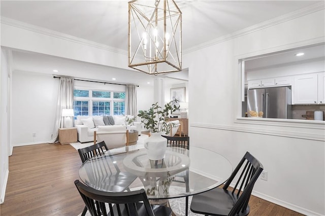 2070 Drew Valley Rd NE, Brookhaven, GA 30319 - dining area featuring crown molding, a chandelier, and dark wood-type flooring