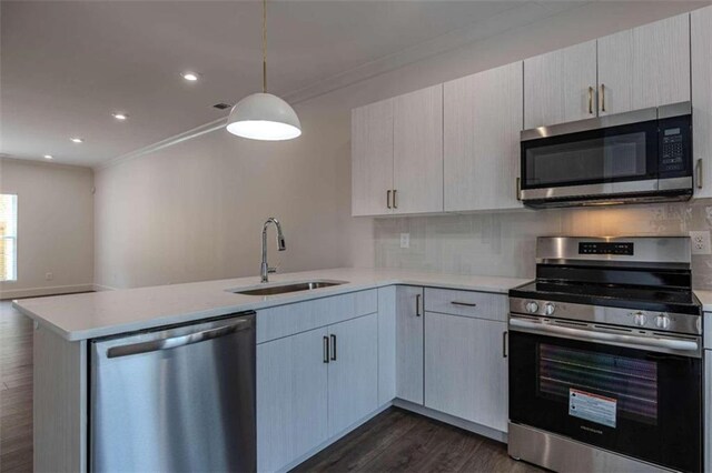 kitchen with sink, light stone countertops, ornamental molding, light brown cabinetry, and appliances with stainless steel finishes