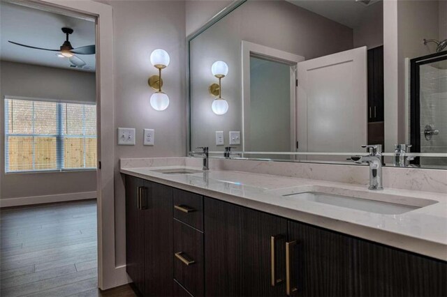 bathroom featuring vanity, wood-type flooring, and washtub / shower combination