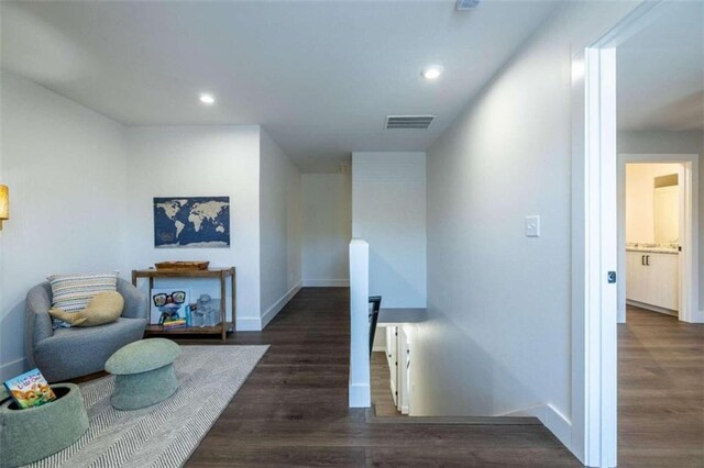 unfurnished bedroom with ceiling fan, dark wood-type flooring, and ensuite bath