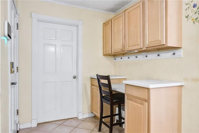 interior space featuring light tile patterned floors, baseboards, and crown molding