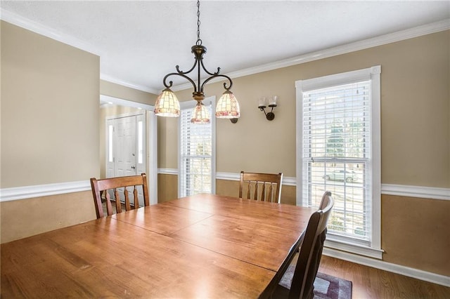 dining room featuring a notable chandelier, wood finished floors, and ornamental molding