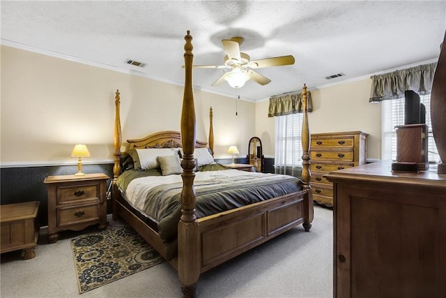 bedroom featuring visible vents, light colored carpet, crown molding, and multiple windows