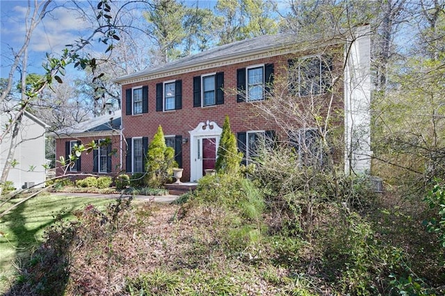 colonial home with brick siding