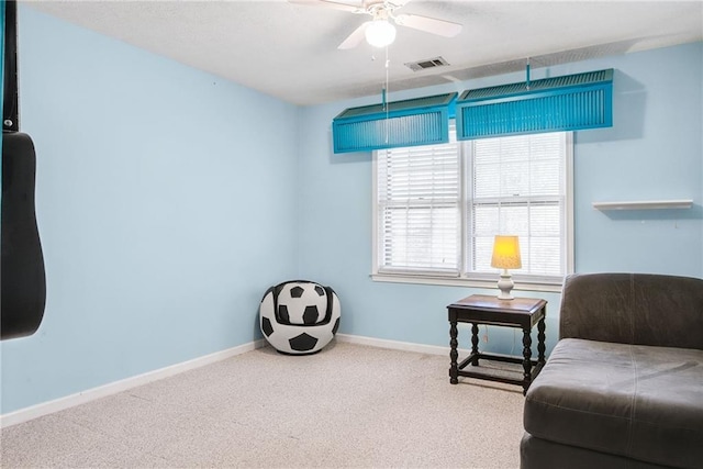 sitting room featuring visible vents, a ceiling fan, baseboards, and carpet floors