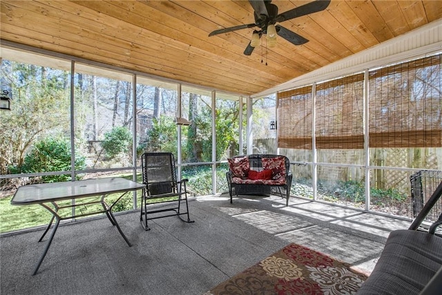 sunroom / solarium featuring plenty of natural light, wood ceiling, and ceiling fan