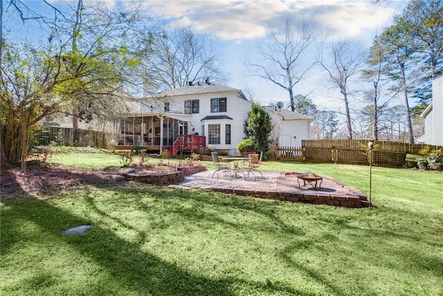 rear view of house with a yard, a patio area, fence, and a sunroom