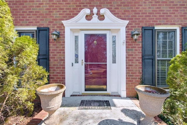 doorway to property with brick siding