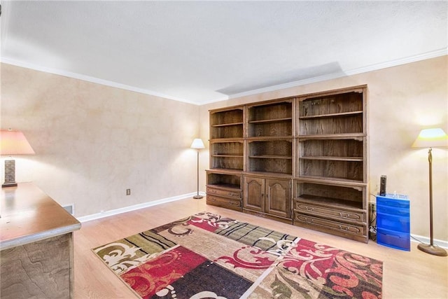 sitting room with visible vents, baseboards, wood finished floors, and crown molding