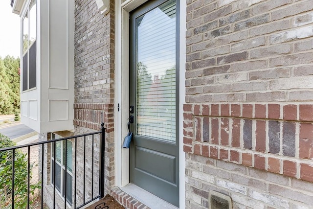 view of exterior entry featuring a balcony