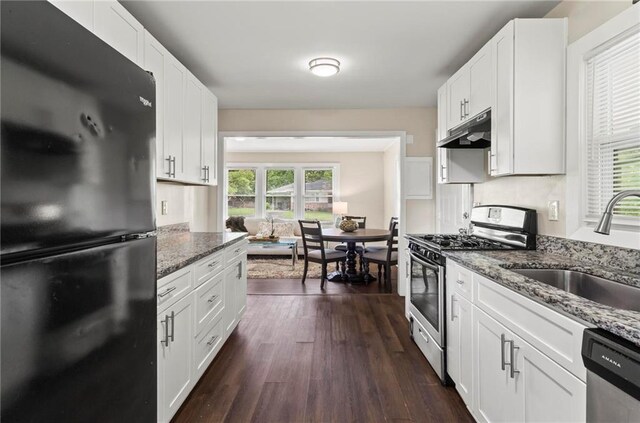 629 Dunton Cir SE, Smyrna, GA 30082 - kitchen featuring appliances with stainless steel finishes, under cabinet range hood, a sink, and dark wood-style flooring