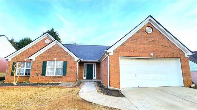 ranch-style house with a garage and a front yard