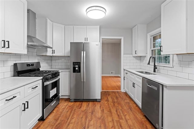 2002 Twin Falls Rd, Decatur, GA 30032 - kitchen featuring appliances with stainless steel finishes, wall chimney exhaust hood, light countertops, and white cabinets