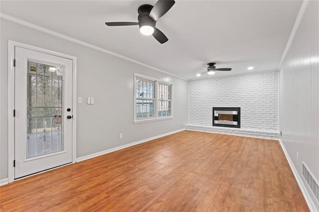 2002 Twin Falls Rd, Decatur, GA 30032 - unfurnished living room featuring crown molding, a ceiling fan, light wood-type flooring, and a fireplace