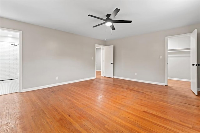 2002 Twin Falls Rd, Decatur, GA 30032 - unfurnished bedroom featuring light wood finished floors, a walk in closet, ensuite bath, a ceiling fan, and a closet