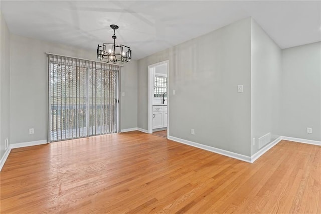 2002 Twin Falls Rd, Decatur, GA 30032 - unfurnished room with a chandelier and light wood finished floors