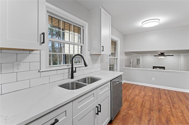 2002 Twin Falls Rd, Decatur, GA 30032 - kitchen featuring stainless steel dishwasher, backsplash, ceiling fan, white cabinetry, and light stone counters
