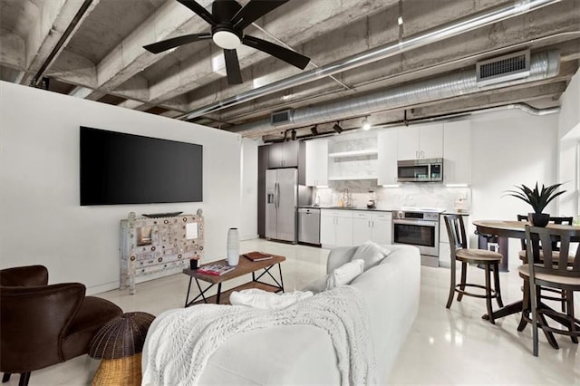 living room with ceiling fan and sink