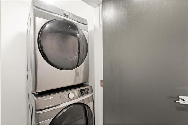 washroom featuring stacked washer / dryer