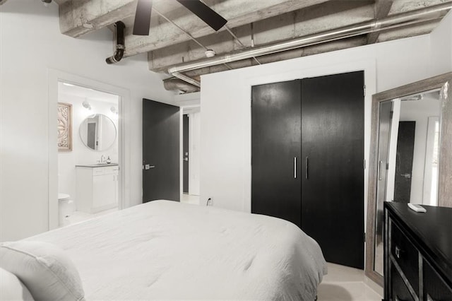 bedroom featuring ensuite bath, sink, and a closet