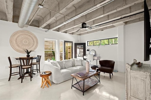 living room with concrete floors and ceiling fan