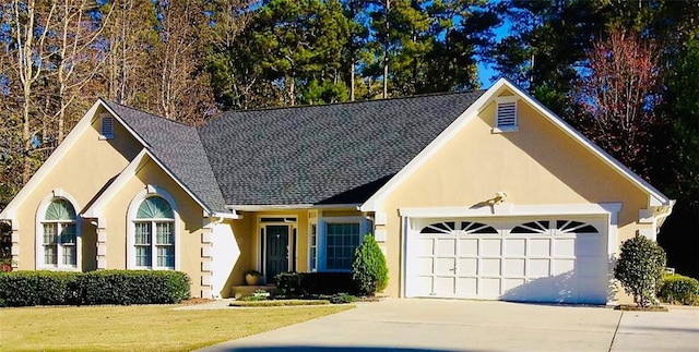 view of front of property featuring a garage and a front lawn