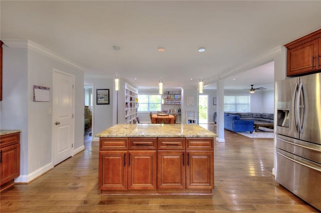 2944 Berry Rd, Loganville, GA 30052 - kitchen featuring ornamental molding, wood finished floors, open floor plan, stainless steel refrigerator with ice dispenser, and a center island
