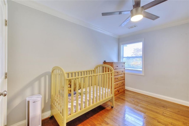 2944 Berry Rd, Loganville, GA 30052 - bedroom with visible vents, baseboards, crown molding, and hardwood / wood-style flooring