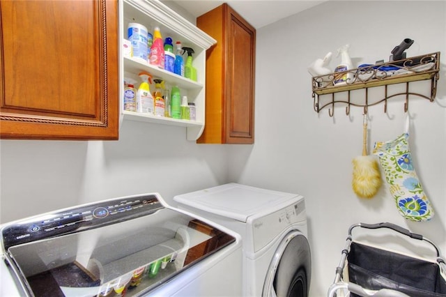2944 Berry Rd, Loganville, GA 30052 - clothes washing area featuring independent washer and dryer and cabinet space