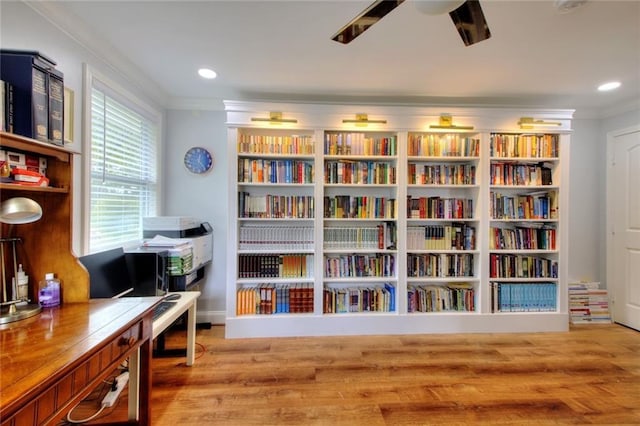 2944 Berry Rd, Loganville, GA 30052 - sitting room with wall of books, a ceiling fan, crown molding, wood finished floors, and recessed lighting