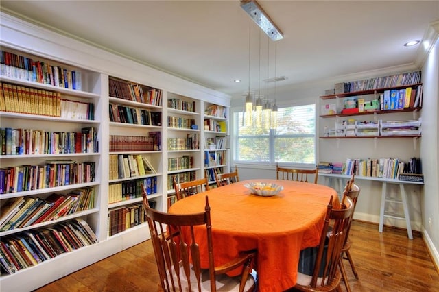 2944 Berry Rd, Loganville, GA 30052 - dining room with crown molding, baseboards, visible vents, and hardwood / wood-style floors