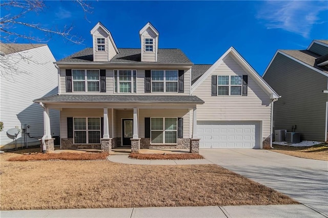 view of front of house featuring central AC, a garage, and covered porch