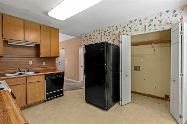 5340 Young Deer Dr, Cumming, GA 30041 - kitchen with black appliances, wallpapered walls, a sink, light flooring, and light countertops