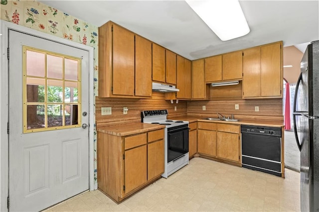 5340 Young Deer Dr, Cumming, GA 30041 - kitchen featuring black appliances, under cabinet range hood, a sink, light floors, and wallpapered walls
