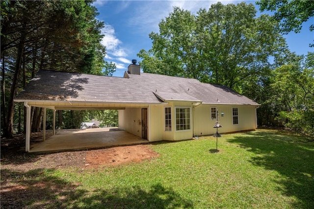 5340 Young Deer Dr, Cumming, GA 30041 - rear view of house with a carport, a chimney, and a yard
