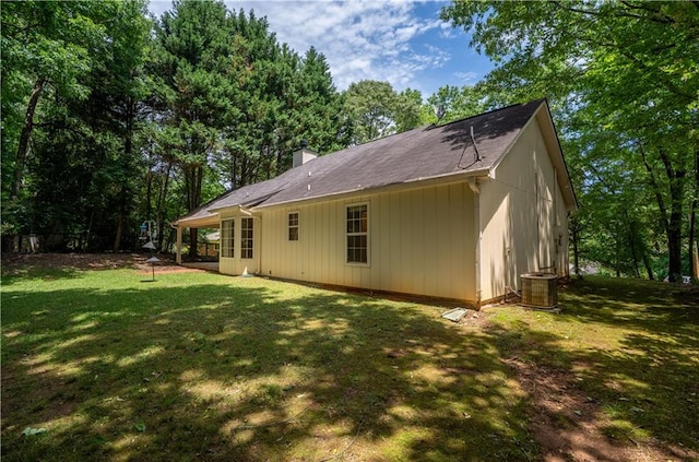 5340 Young Deer Dr, Cumming, GA 30041 - rear view of property with central AC unit, a chimney, and a yard