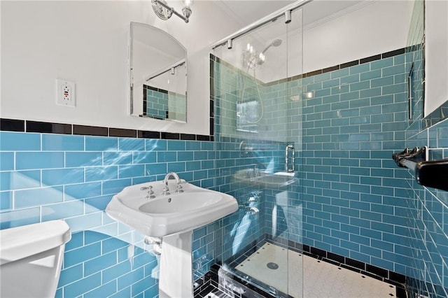 bathroom featuring tile walls, an enclosed shower, and toilet