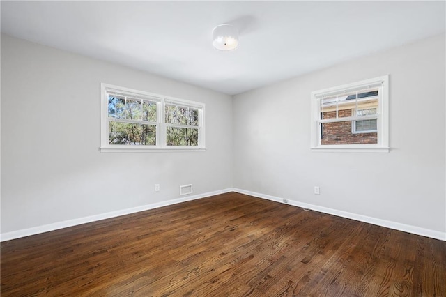 spare room with dark hardwood / wood-style floors