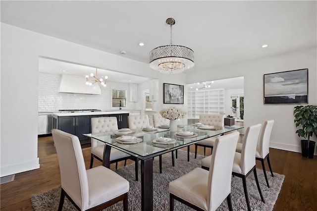 dining area with an inviting chandelier and dark hardwood / wood-style floors