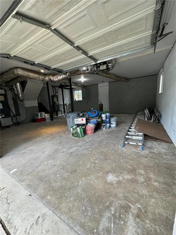 garage featuring concrete block wall and a garage door opener