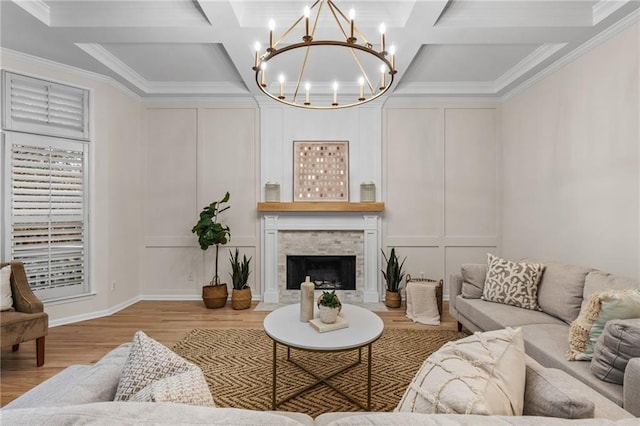 living room featuring light hardwood / wood-style floors, a fireplace, beamed ceiling, and coffered ceiling