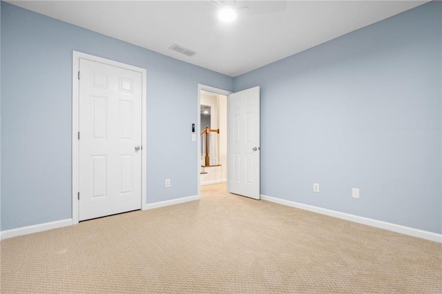 unfurnished bedroom with light colored carpet