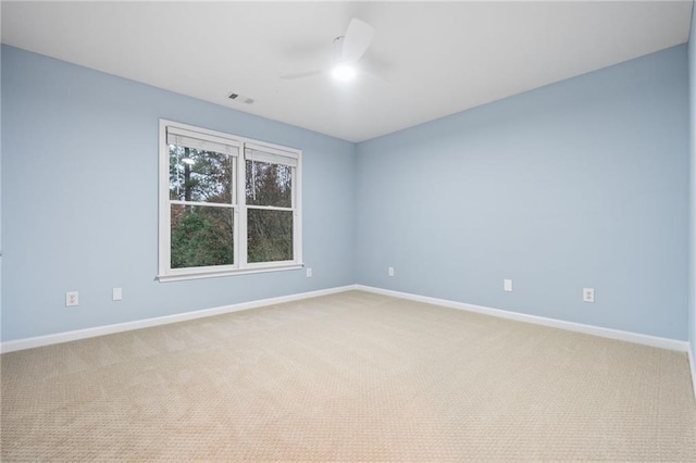 carpeted empty room featuring ceiling fan