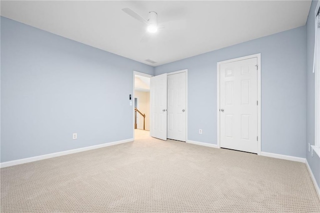 unfurnished bedroom with light carpet and ceiling fan