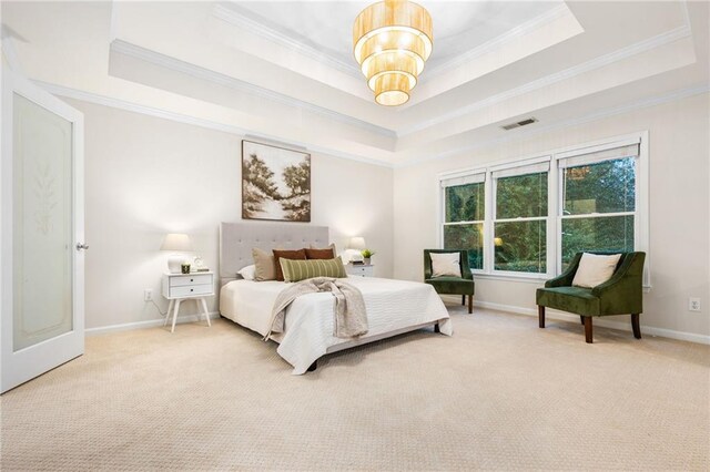 bedroom featuring crown molding, carpet, and a tray ceiling